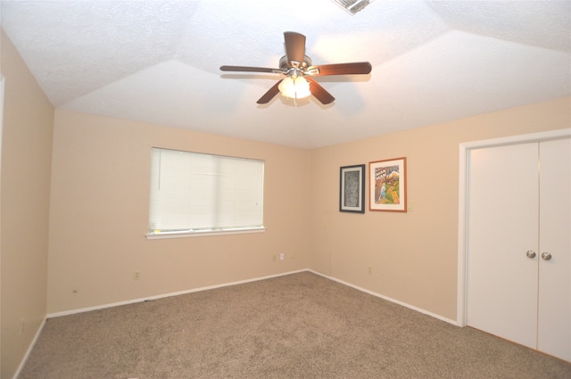 unfurnished bedroom with a closet, carpet flooring, a ceiling fan, and baseboards