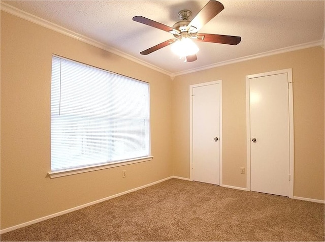 unfurnished bedroom with ornamental molding, carpet, and a textured ceiling