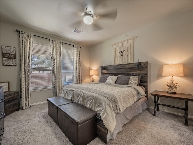 bedroom featuring light carpet, visible vents, baseboards, and ceiling fan