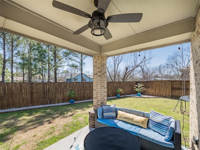 view of patio / terrace with a ceiling fan, an outdoor living space, and a fenced backyard