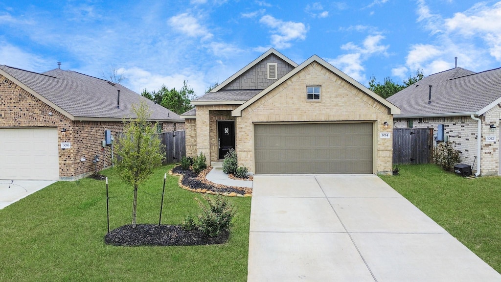 view of front of home featuring brick siding, a front yard, and fence