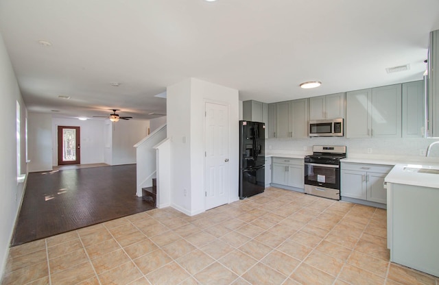 kitchen featuring a sink, visible vents, light countertops, appliances with stainless steel finishes, and gray cabinets