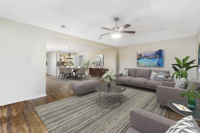 living room with visible vents, a ceiling fan, a textured ceiling, wood finished floors, and baseboards