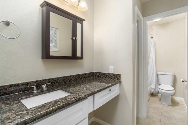 full bathroom with curtained shower, toilet, vanity, baseboards, and tile patterned floors