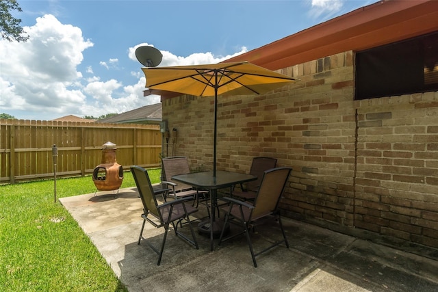 view of patio with outdoor dining area and fence