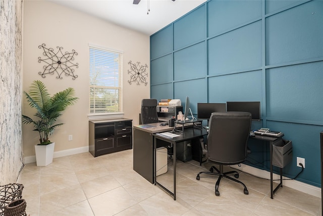 office space with light tile patterned floors, ceiling fan, and baseboards