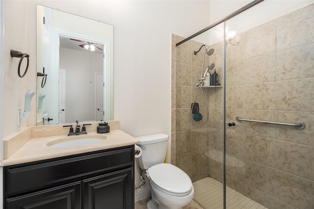 bathroom featuring toilet, a shower stall, and vanity