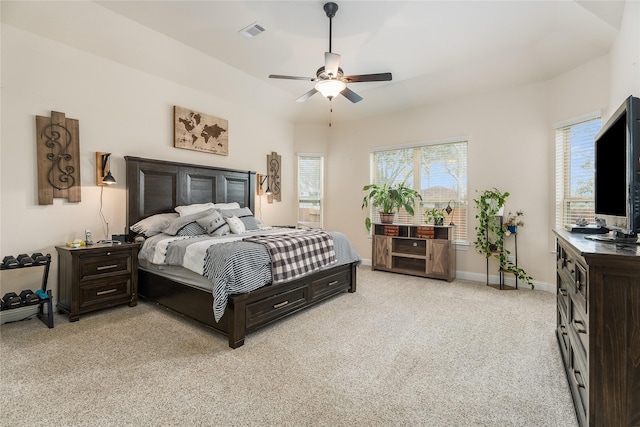 bedroom featuring light carpet, ceiling fan, visible vents, and baseboards