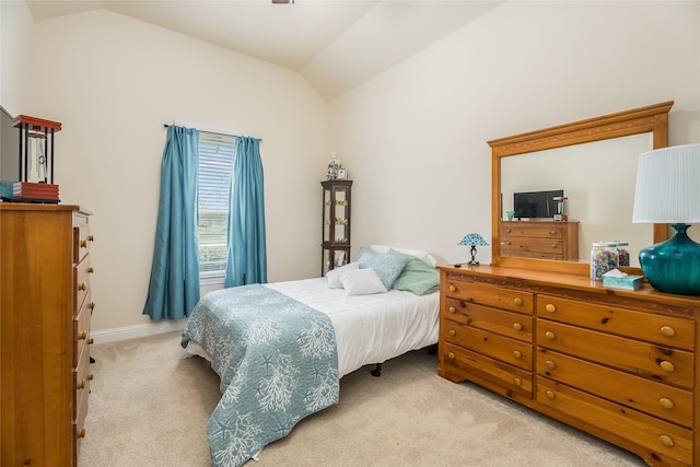 bedroom featuring lofted ceiling and light colored carpet