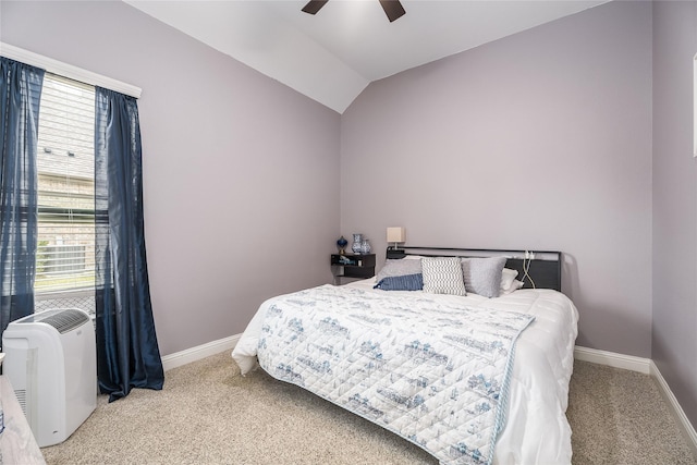 carpeted bedroom with lofted ceiling, a ceiling fan, and baseboards