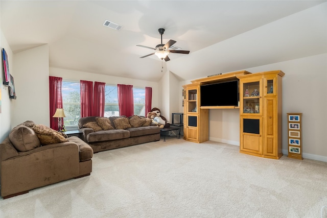 living room featuring light carpet, baseboards, visible vents, ceiling fan, and vaulted ceiling