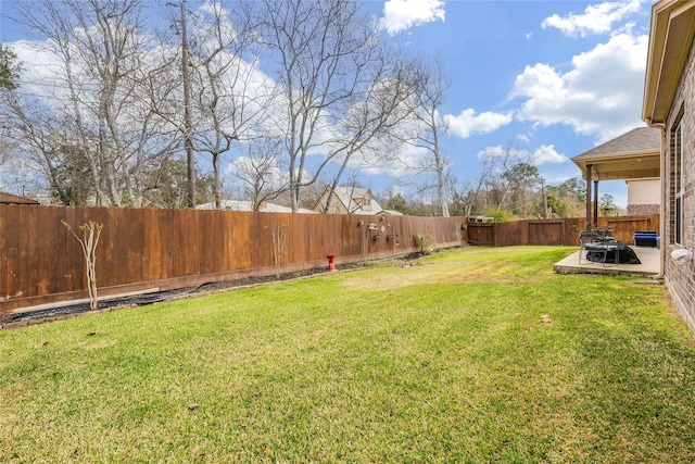 view of yard featuring a patio area and a fenced backyard