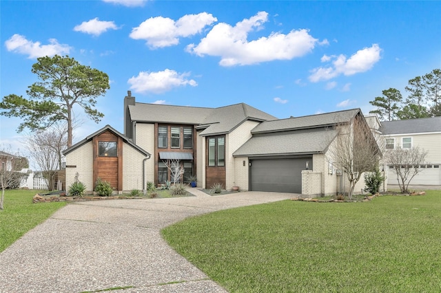 view of front of house with a garage, concrete driveway, a front lawn, and a chimney