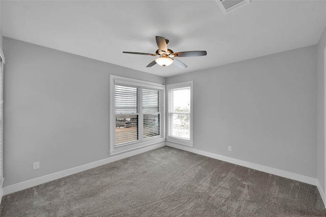 unfurnished room featuring ceiling fan, carpet floors, visible vents, and baseboards