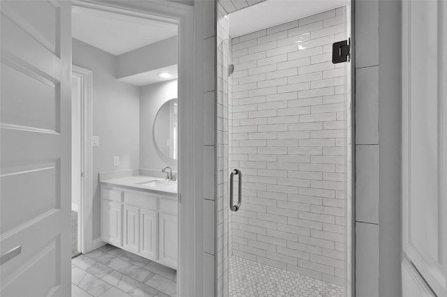 bathroom featuring marble finish floor, a shower stall, and vanity