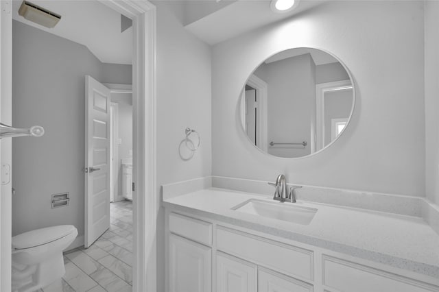 bathroom featuring toilet, marble finish floor, visible vents, and vanity