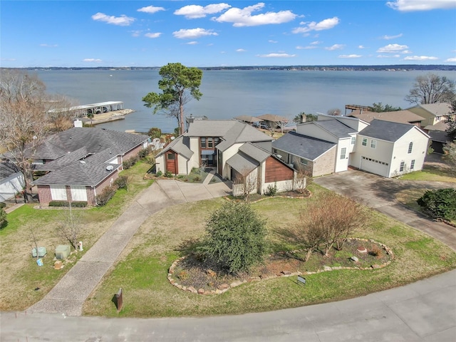 bird's eye view featuring a water view and a residential view