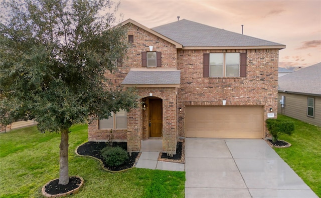 traditional-style house featuring a garage, a front lawn, concrete driveway, and brick siding