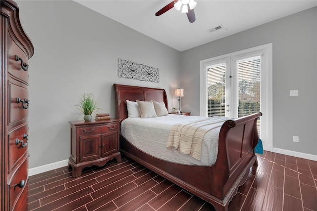 bedroom featuring access to outside, visible vents, baseboards, and wood tiled floor