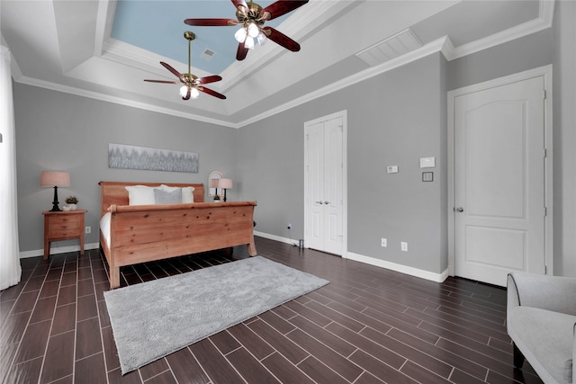 bedroom with wood finish floors, visible vents, and baseboards