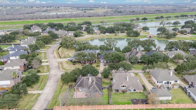 drone / aerial view with a water view and a residential view