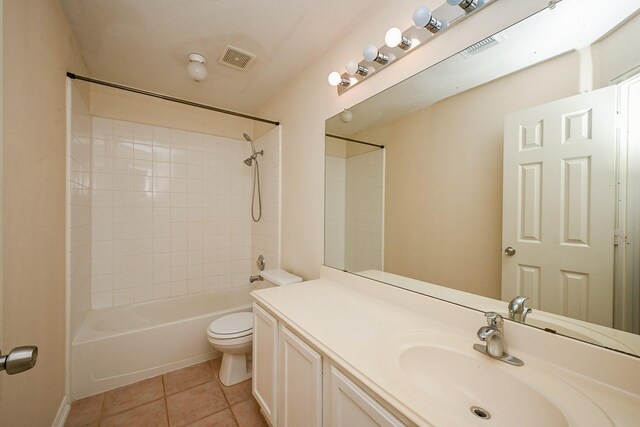 full bath with shower / bath combination, visible vents, toilet, vanity, and tile patterned floors