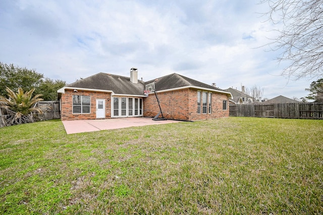 31 Crest Gate, Houston, TX 77082 - back of property with brick siding, a patio, and a chimney