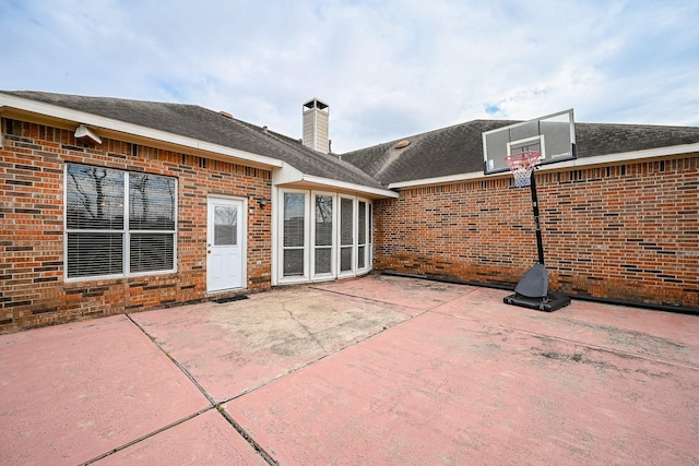 31 Crest Gate, Houston, TX 77082 - back of house with brick siding, a chimney, and a patio area