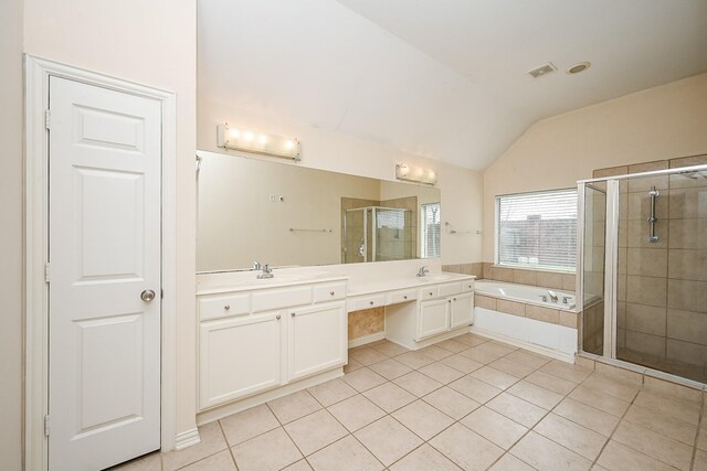 bathroom with lofted ceiling, tile patterned flooring, a shower stall, a bath, and double vanity