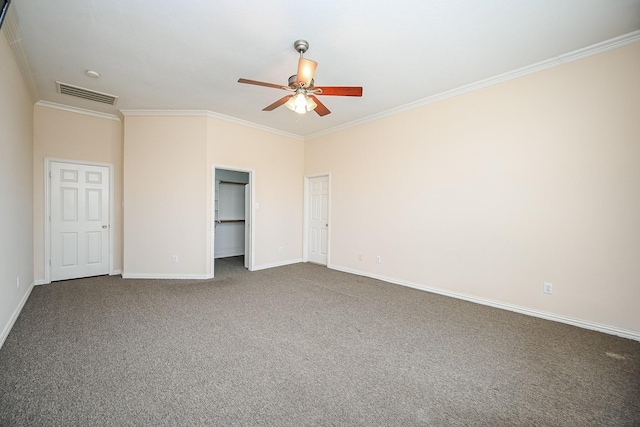 unfurnished bedroom featuring visible vents, baseboards, a ceiling fan, ornamental molding, and carpet