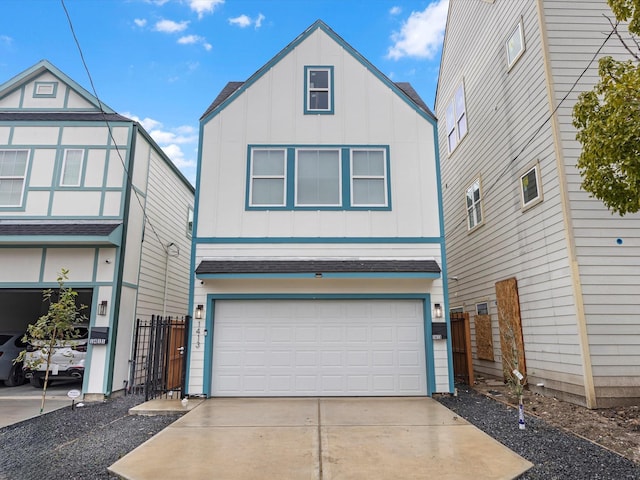 view of front of house with board and batten siding, concrete driveway, fence, and a garage