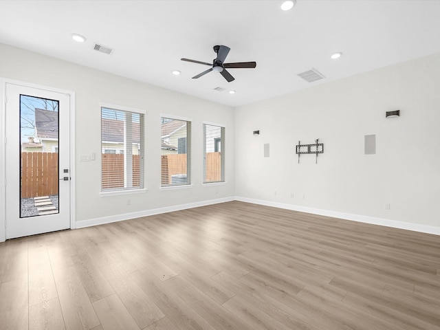 unfurnished room featuring wood finished floors, visible vents, and recessed lighting