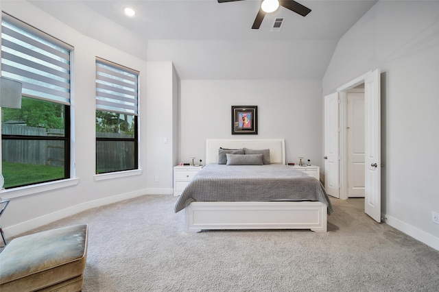 carpeted bedroom featuring a ceiling fan, lofted ceiling, visible vents, and baseboards