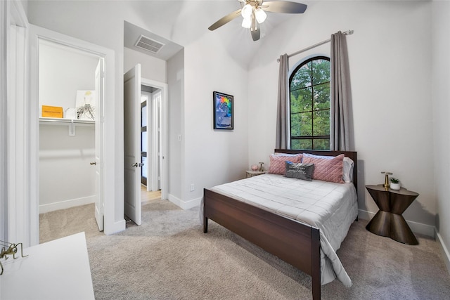 bedroom featuring lofted ceiling, carpet, visible vents, and baseboards