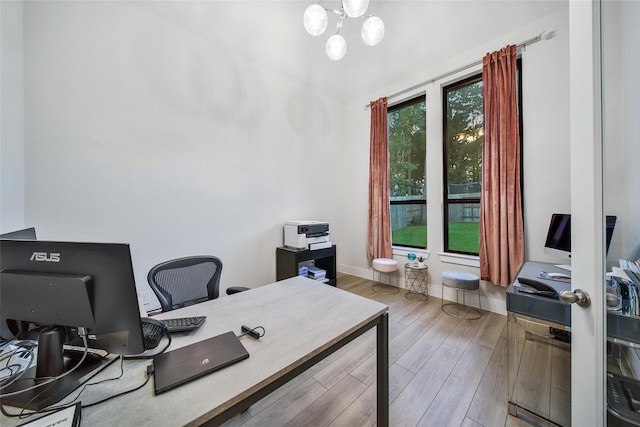 office area with a notable chandelier, baseboards, and wood finished floors