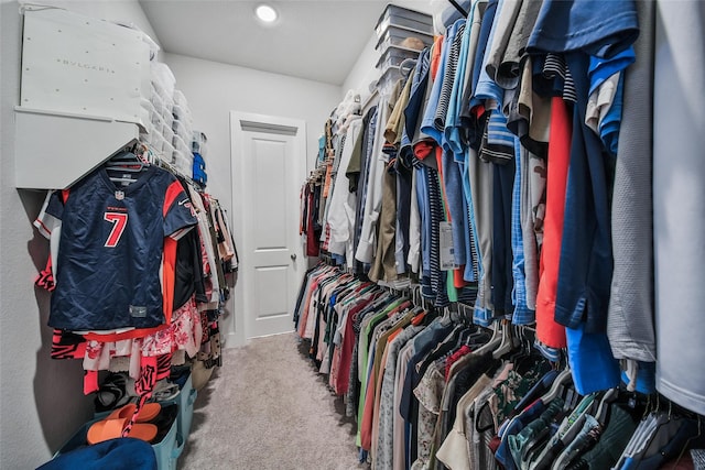 walk in closet with carpet