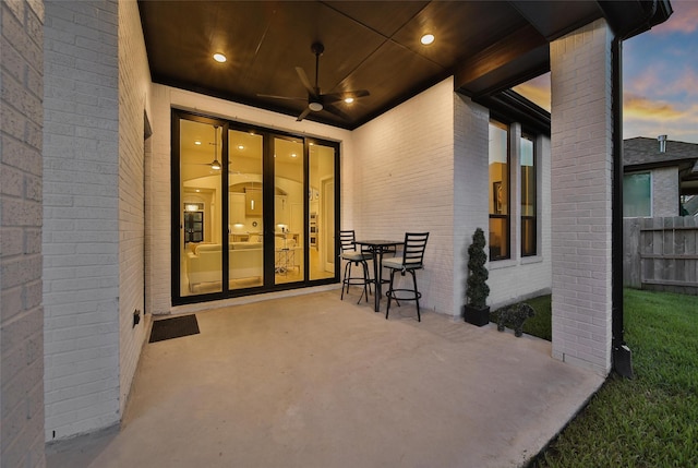 view of patio featuring french doors, fence, and a ceiling fan