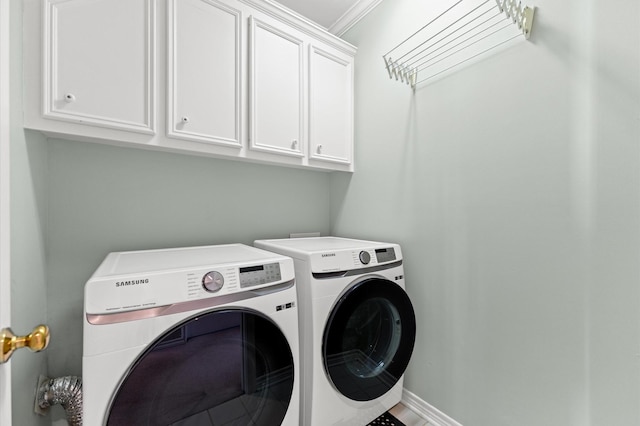 laundry area with cabinet space, independent washer and dryer, and baseboards