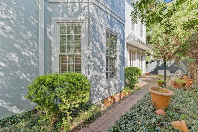 view of side of home featuring fence