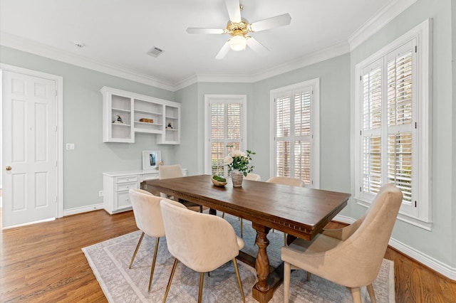 dining area with light wood-type flooring, baseboards, and a wealth of natural light