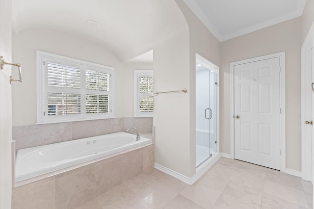 full bathroom with a stall shower, baseboards, and a bath