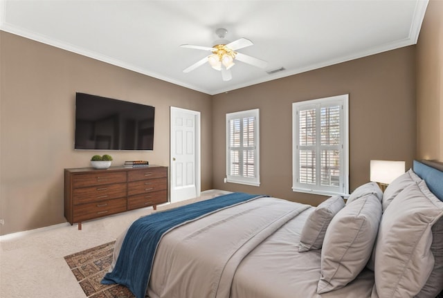 carpeted bedroom featuring ornamental molding, visible vents, and ceiling fan