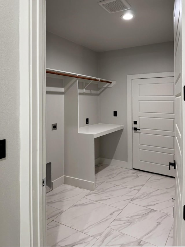 clothes washing area with laundry area, baseboards, visible vents, marble finish floor, and electric dryer hookup