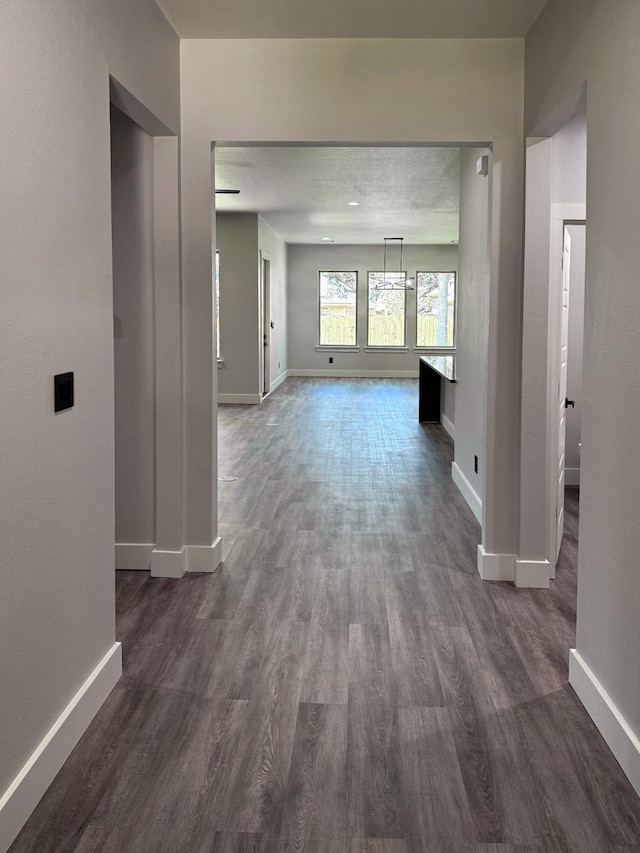 interior space featuring dark wood-style floors and baseboards