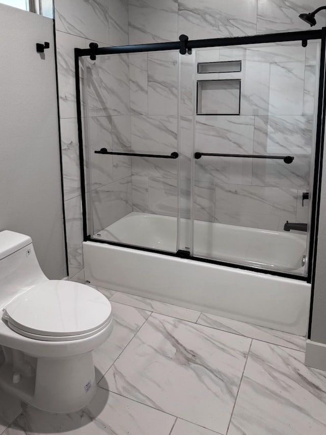 full bath featuring toilet, marble finish floor, and combined bath / shower with glass door