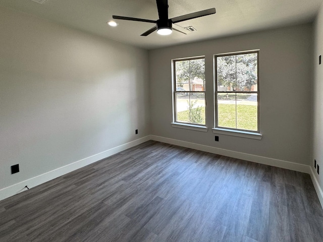 empty room featuring ceiling fan, recessed lighting, dark wood-style flooring, visible vents, and baseboards