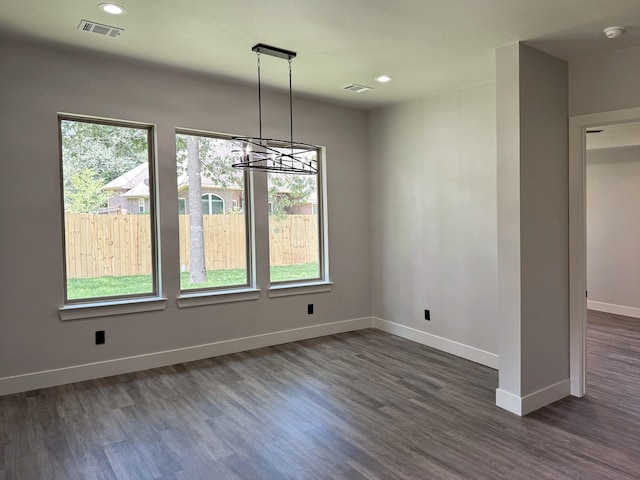 unfurnished dining area with recessed lighting, visible vents, dark wood finished floors, and baseboards