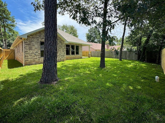 view of yard with a fenced backyard