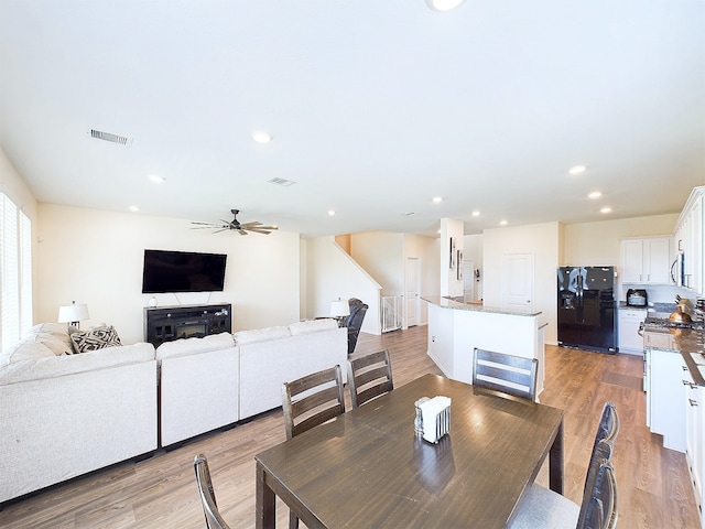 dining space featuring recessed lighting, a ceiling fan, visible vents, stairs, and light wood-type flooring