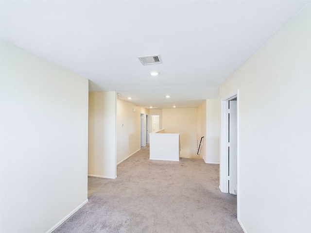 unfurnished room featuring light carpet, baseboards, visible vents, and recessed lighting